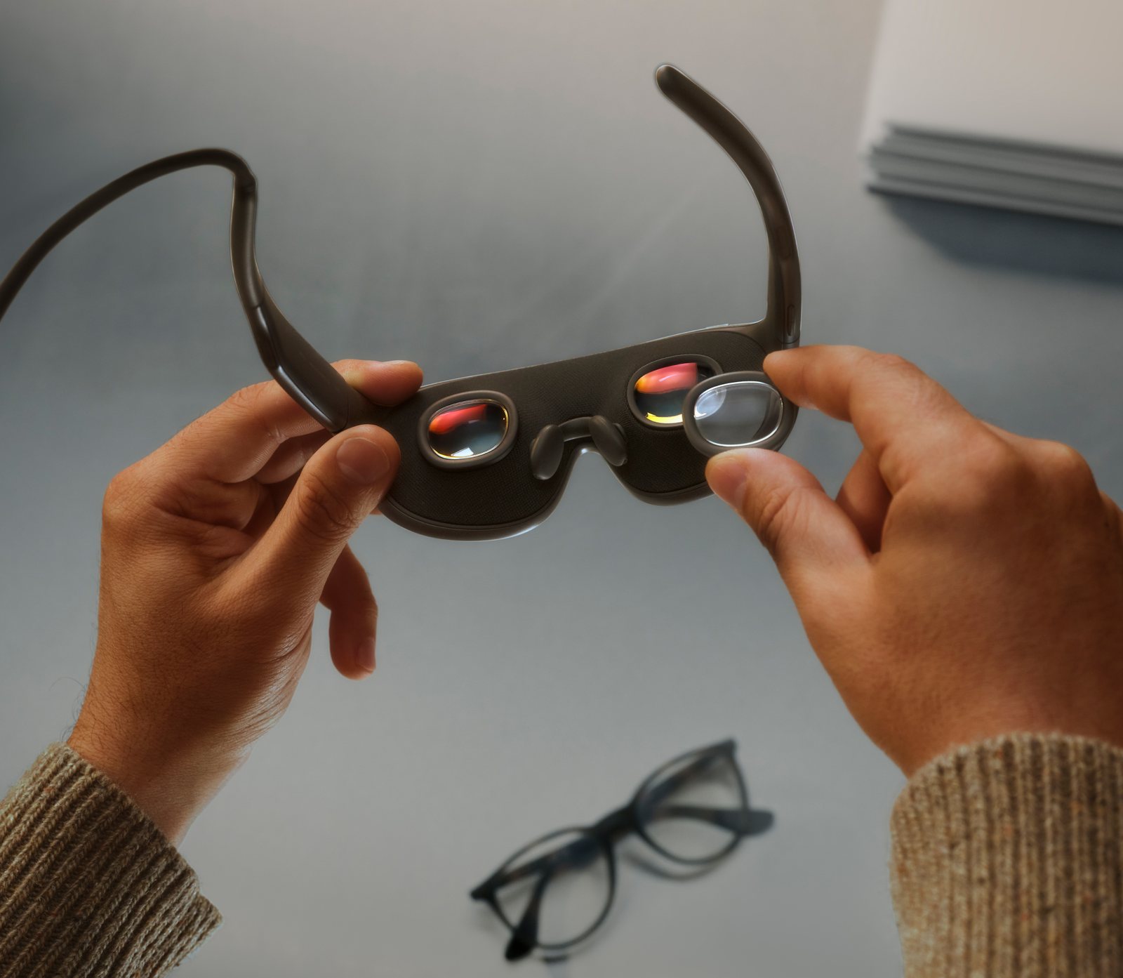 Hands holding Meta VR Glasses to show the pancake lenses
